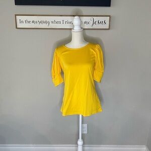 Yellow quarter length sleeved shirt.
